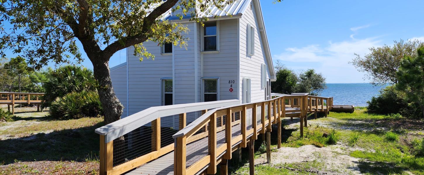 A boardwalk leads to one of eight cabins with a view of St. Joseph Bay.