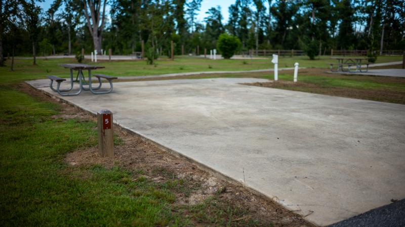 A concrete pad marks one of campsites in the campground at Florida Caverns State Park.  