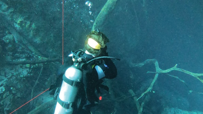 FGS geologist Dr. Ben Davis enjoying a weekend exploring Orange Grove Sink and peering into the Peacock Springs caves system.